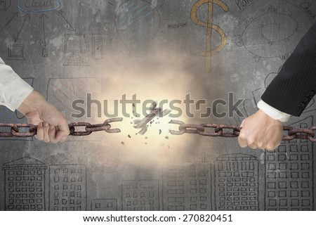 Businessman pulling rusty iron chains broken with red bright spark light on gray doodles concrete wall background, tug of war, business competitive concept.