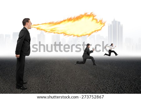 Angry businessman yelling at employees and spitting fire flame from mouth on asphalt floor and urban scene skyline background