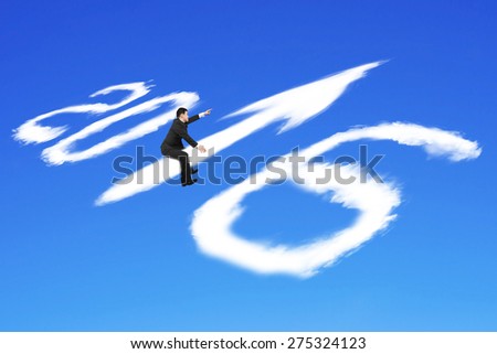 Man riding white 2016 year arrow up sign shape clouds with raised finger pointing direction on blue sky background
