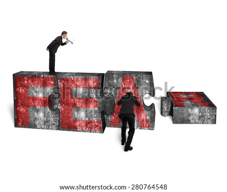 Businessman using speaker yelling at other man pushing big jigsaw puzzle concrete blocks with red FEAR word, isolated on white background