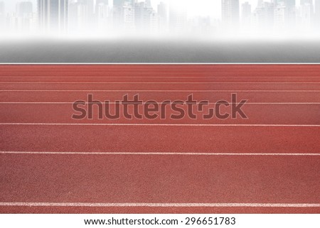 Running track, with gray city skyline background.