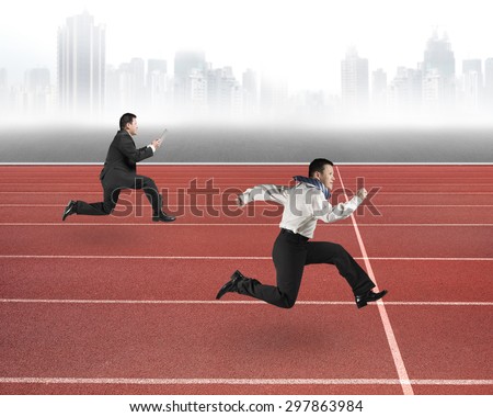Two businessmen running on red track, with gray urban skyline background.