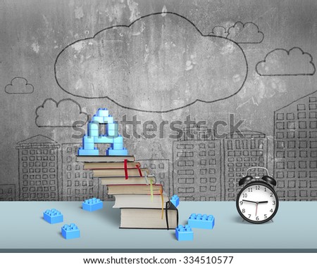 Alphabet letter A shape blocks on top of stack books stairs with alarm clock on table, with doodles concrete wall background.