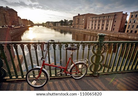 Old red bicycle on Egyptian Bridge. Fontanka River, Saint-Petersburg, Russia