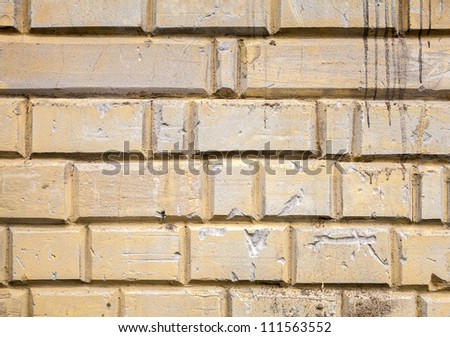 Background texture of old yellow painted concrete wall with decorative elements