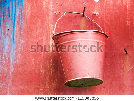 Fire fighting equipment, red metal bucket on the wall