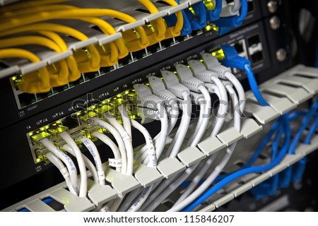 Large network hub and connected Internet cables. Selective focus