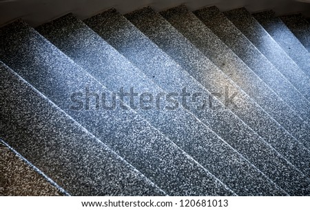 Dark stone shining stairs goes down. Abstract architecture fragment