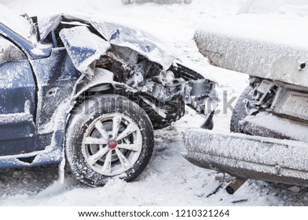 Crashed cars right after an accident on winter road with snow