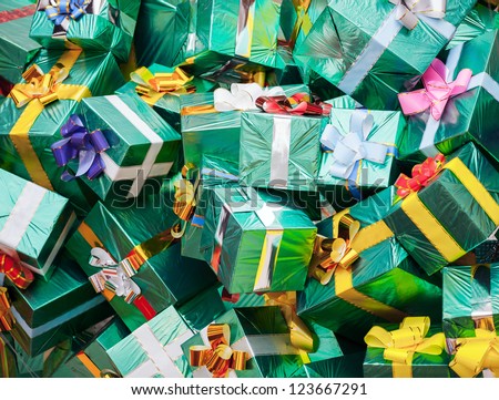 Huge pile of green gift boxes with colorful bows