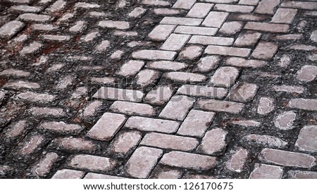 Background texture of damaged old cobblestone road
