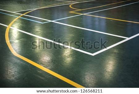 Green shining floor of sports hall with marking lines