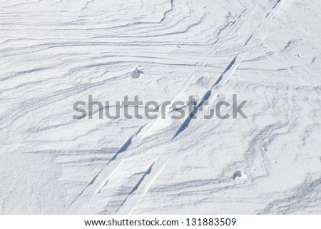 Snow and Ski track above shining snowdrift with nice curved shadows