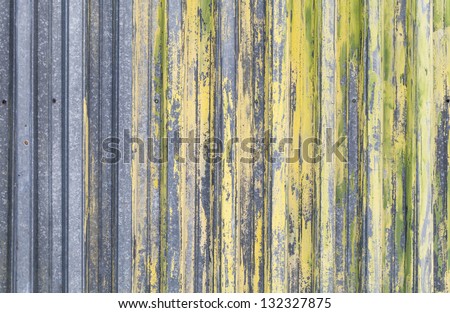 Ridged yellow painted old metal wall background texture