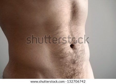Flat man\'s belly. Closeup photo with shallow depth of field