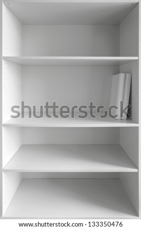 White cabinet with empty shelves and two books