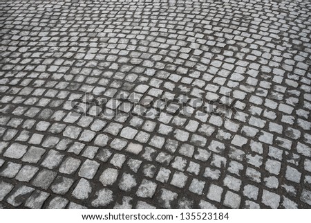 Background texture of old granite cobblestone road surface