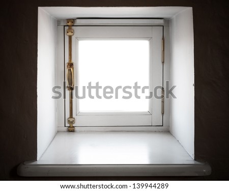 Small square window in the wall of old European house
