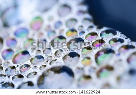 Macro of colorful soap bubbles on the water
