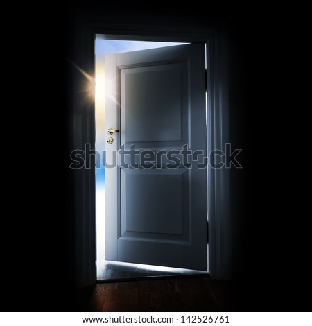 Opening blue door in a dark room with shining light and sky outside