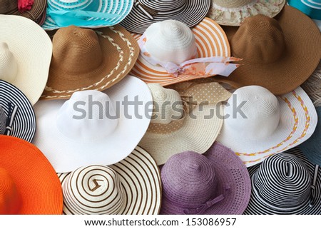 Colorful female summer hats lie on the counter