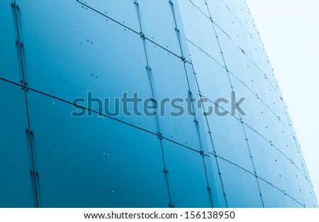 Abstract architecture fragment with blue wet steel panels