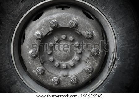 Abstract transportation background. Closeup photo texture of big cargo truck wheel