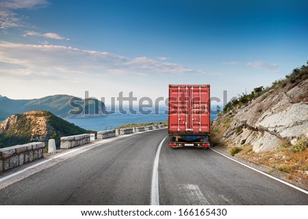 Cargo Truck On The Mountain Highway With Blue Sky And Sea On A Background