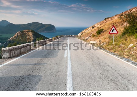Dividing line and right turn sign on the coastal mountain highway. Montenegro