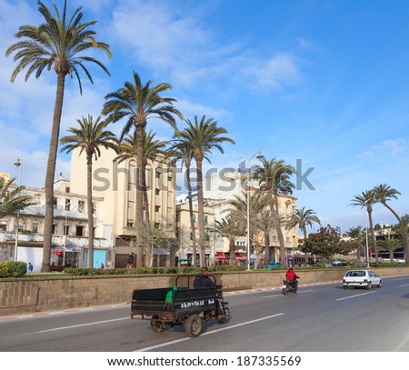 TANGIER, MOROCCO - MARCH 22, 2014: Old tricycle cargo bike with Arab driver rides on the street of  Tangier. This is traditional cargo transport for agrarian market trader