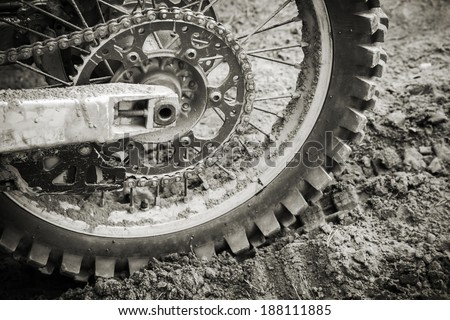 Rear wheel of sport bike on dirty motocross road