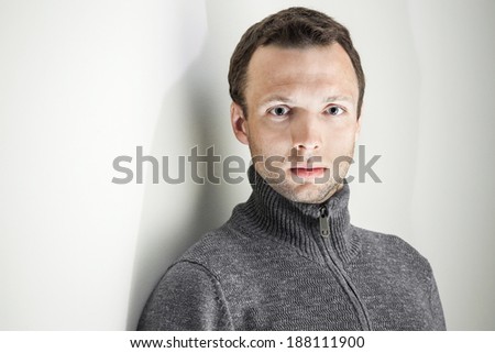 Portrait of young handsome Caucasian man on white background
