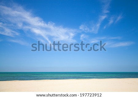 Beautiful cloudy sky over white sandy beach. Nature background