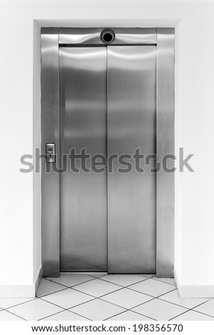 Modern office fragment, shining metal elevator doors