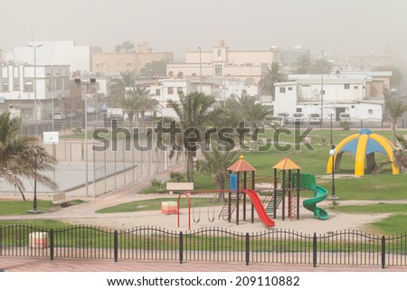 Dust storm. Playground with palms, Saudi Arabia