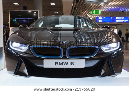 FRANKFURT, GERMANY - AUGUST 28, 2014: Photo of black BMW series i8 innovation car. Advertising stand in the passenger terminal, airport of Frankfurt