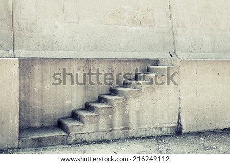 Concrete interior with stairway on the wall, vintage toned photo