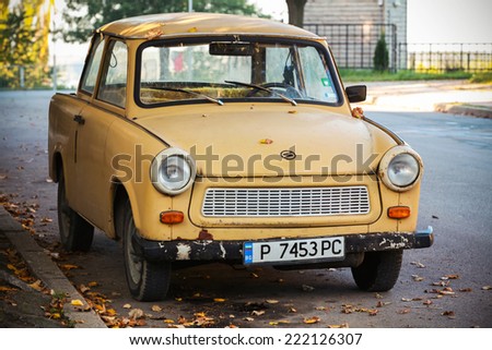 RUSE, BULGARIA - SEPTEMBER 29, 2014: Old yellow Trabant 601s car stands parked on a street side