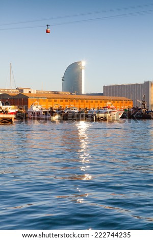 BARCELONA, SPAIN - AUGUST 27, 2014: Barcelona harbor with modern office tower and cable car cabin in the sky