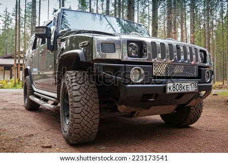 SAINT-PETERSBURG, RUSSIA - OCTOBER 12, 2014: black Hummer H2 car stands on dirty country road in Russia