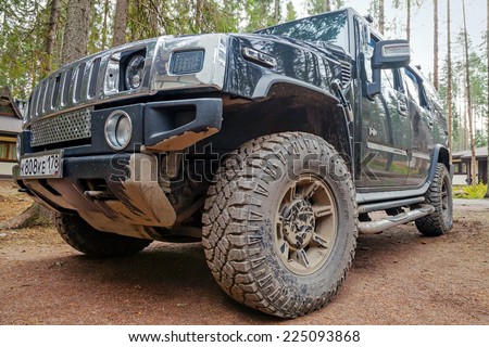 SAINT-PETERSBURG, RUSSIA - OCTOBER 12, 2014: Hummer H2 car stands on dirty country road in Russia