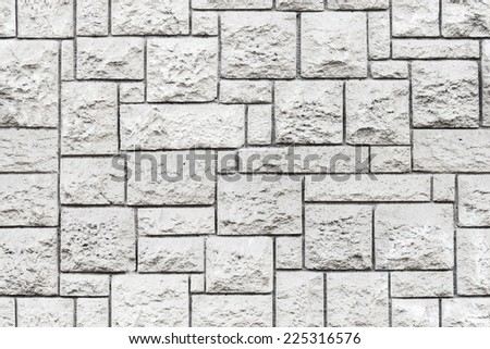 Seamless background texture of old gray decorative stone wall