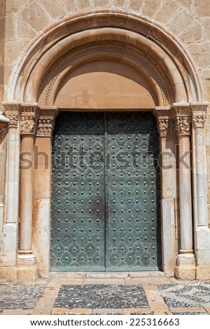 Old metal door, side entrance to the Cathedral of Tarragona, Spain