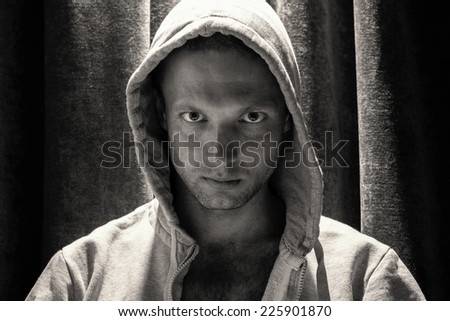 Black and white portrait of young Caucasian man in hood