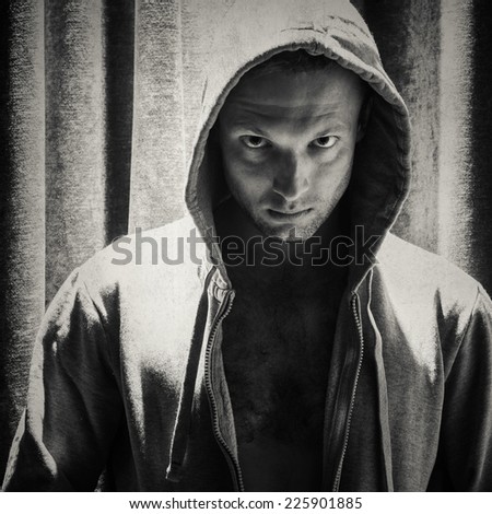 Black and white portrait of young Caucasian sporty man in hood