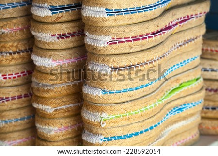 Colorful espadrilles for sale on a small shop counter in Calafell town, Catalonia, Spain