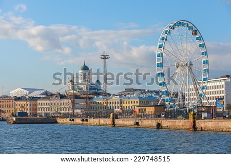 Helsinki, Finland - September 13, 2014: central quay of Helsinki with moored ships, central Cathedral and ferris wheel