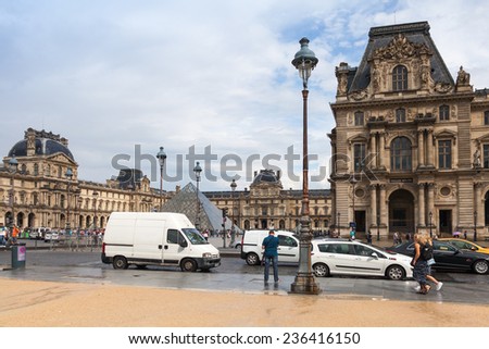 Paris, France - August 07, 2014: Car driving on the street near facade of The Louvre Museum, Paris