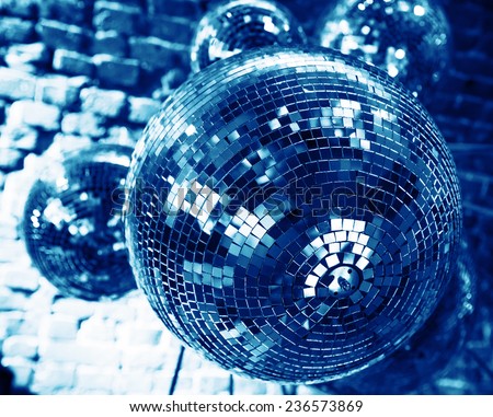 Blue disco party background with mirror balls reflecting lights