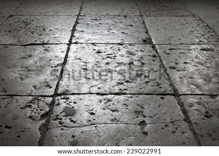 Dark gray stone tiling on the floor, background with perspective effect